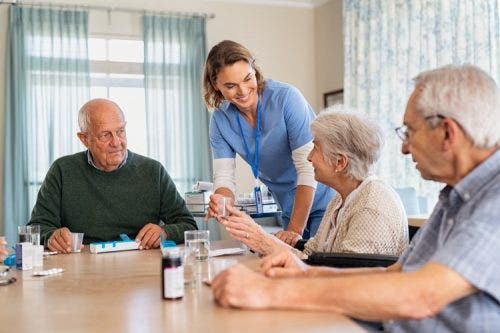 A gerontological nurse practitioner helps patients manage medications.