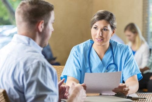 Nurse manager in a hospital listens as a job candidate answers a question during the job interview.