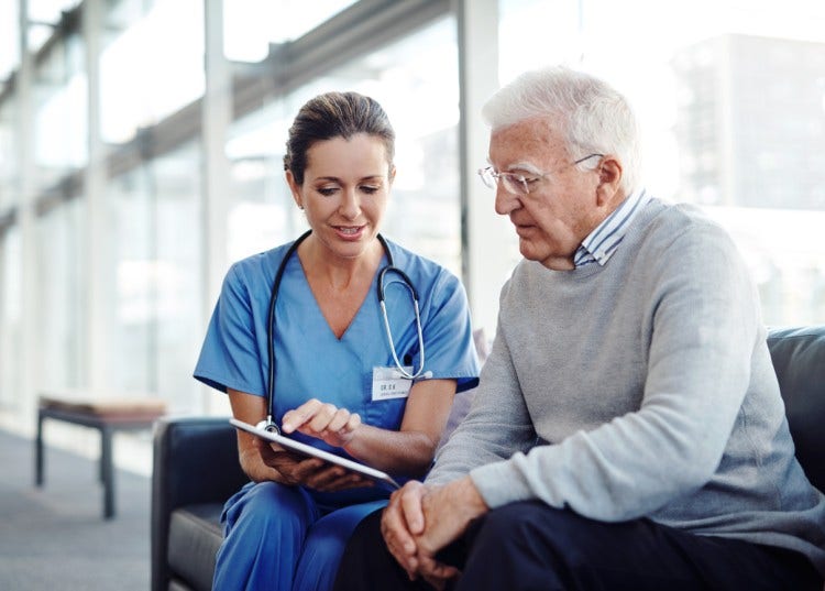 A nurse explains a document to a patient.