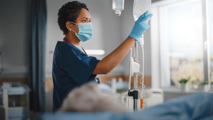 A nurse assesses a patient’s condition on a hospital ward.